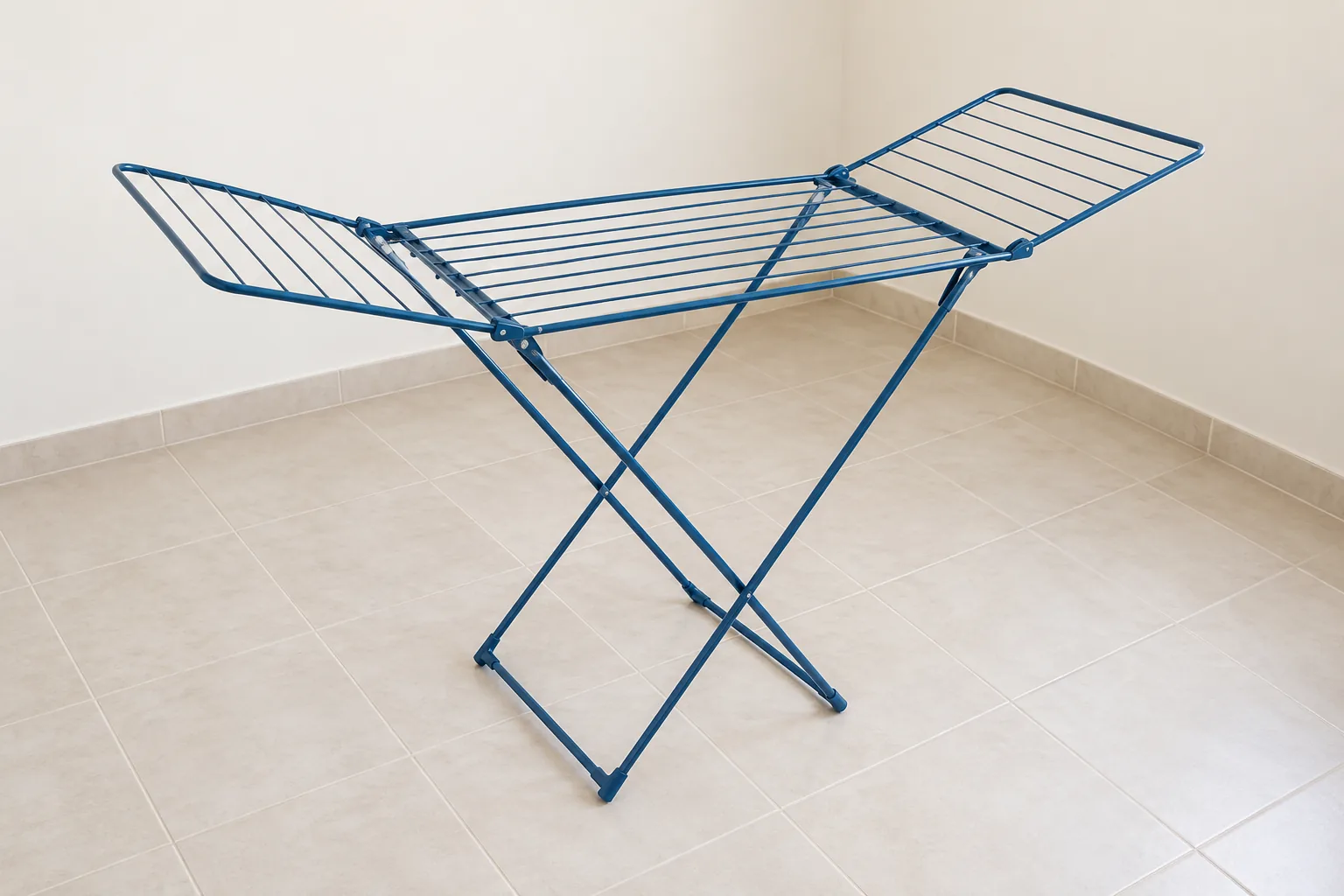 A fully opened marine-blue drying rack with space visible around its frame and wings.